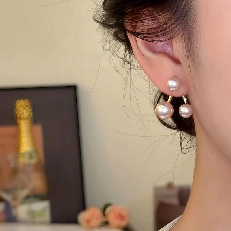 Model showcasing the dangle and style of the 14K Gold-Plated Pearl Jacket Earrings
