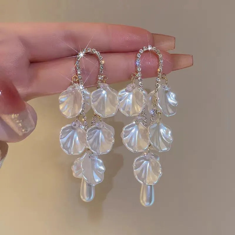 Angled view of the 14K Gold-Plated Pearl Petal Tassel Earrings