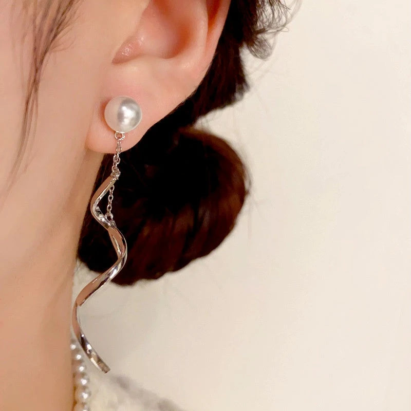 Close-up detail of the sparkling zircons and plating on the Spiral Tassel Earrings