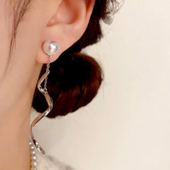 Close-up detail of the sparkling zircons and plating on the Spiral Tassel Earrings