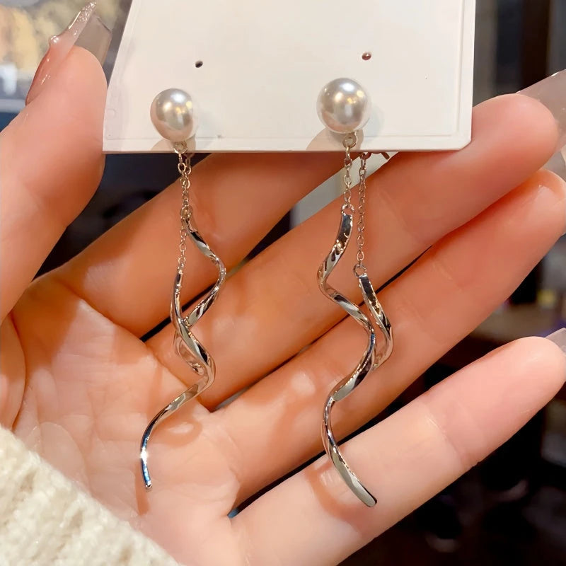 Angled view of the 14K Gold-Plated Pearl Spiral Tassel Earrings
