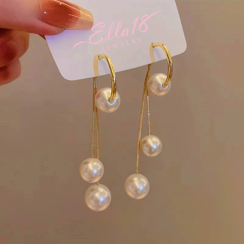 Angled view of the 14K Gold-Plated Pearl Tassel Earrings