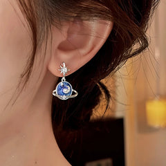 Celestial Silver Star Blue Planet Dangle Earring Worn on Female Ear