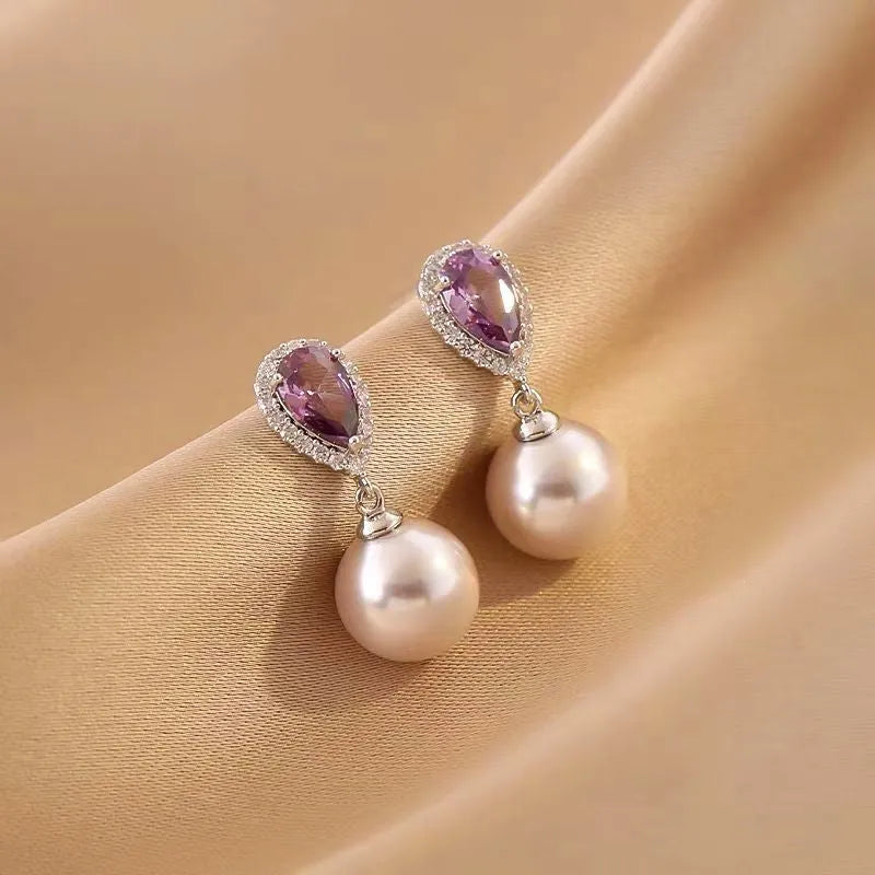 Pair of Teardrop Purple Stone Pearl Drop Earrings on Champagne Satin