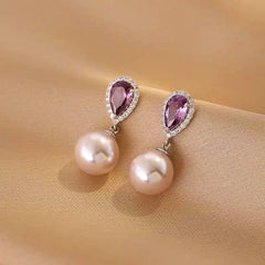 Teardrop Purple Gem Pearl Drop Earrings on Beige Satin Fabric