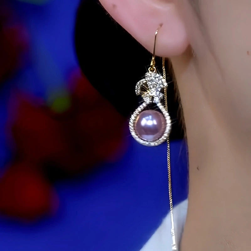 Front view of purple pearl crystal gourd tassel drop earring worn on ear