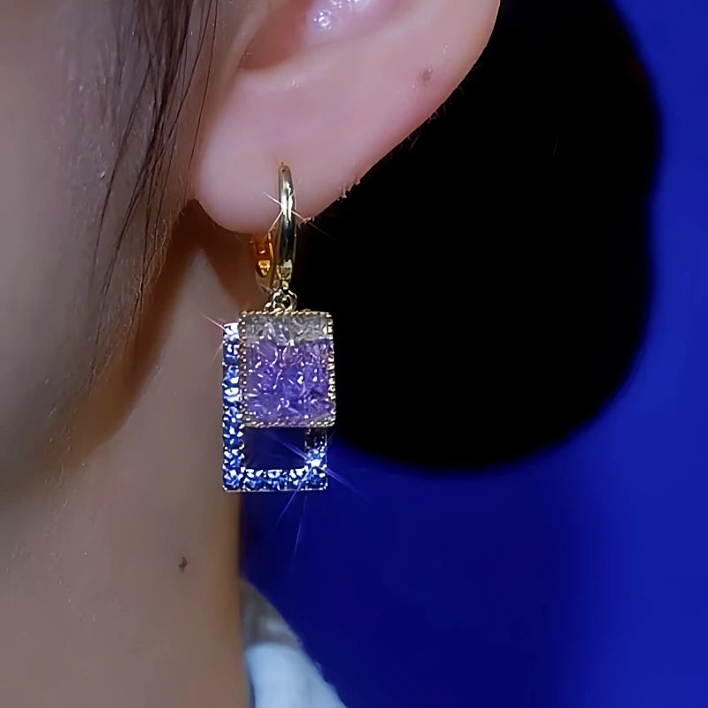 Women's gold purple and blue square crystal drop earring worn on right ear