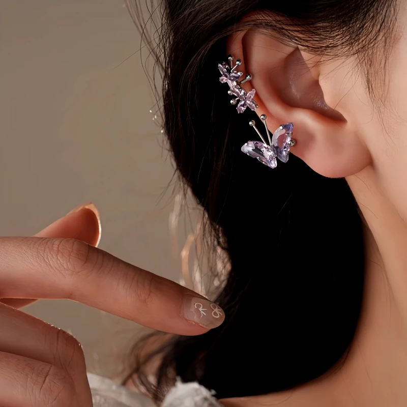 Purple butterfly crystal ear climber earring styled on a woman's ear