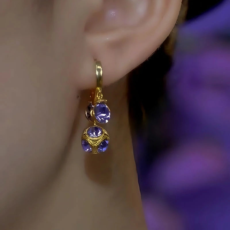 Side view gold purple crystal drop earring worn on ear