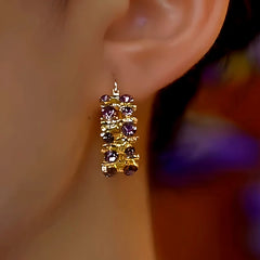 Model showcasing the dangle and style of the 14K Gold-Plated Purple Zircon Diamond Earrings