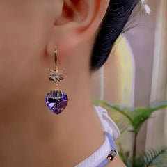 Rose gold fox purple heart crystal drop earring worn on ear, side profile view
