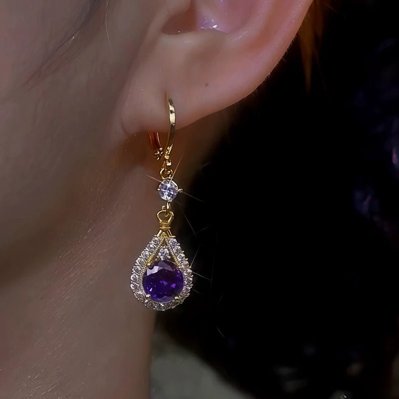Model showcasing the dangle and style of the 14K Gold-Plated Purple Zircon Water Drop Earrings