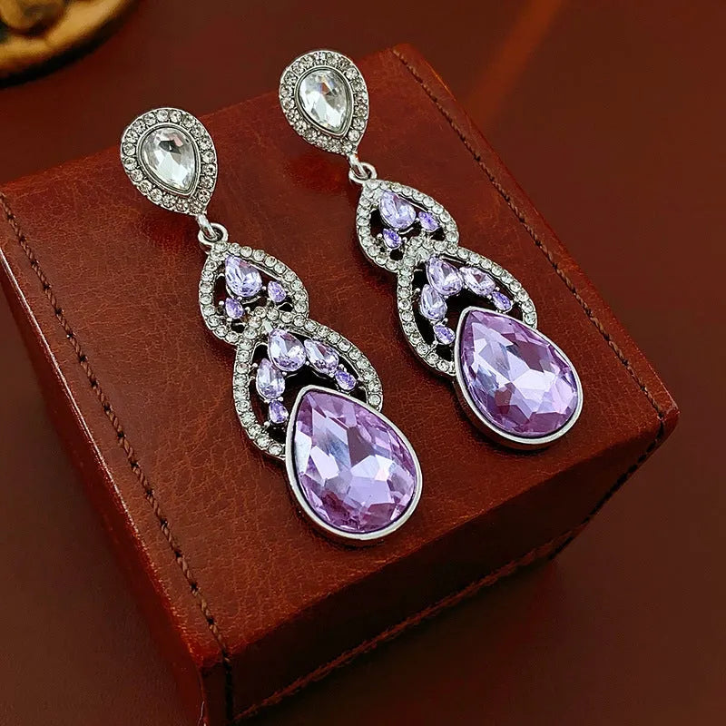 Model showcasing the dangle and style of the 14K Gold-Plated Purple Zircon Water Drop Earrings