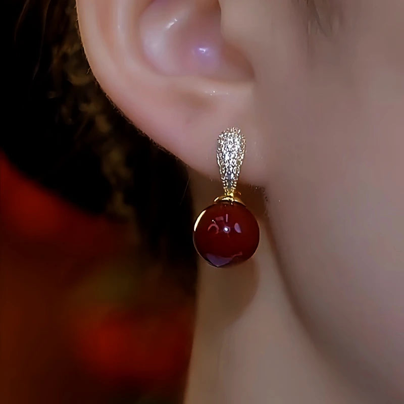 Close-up detail of the sparkling zircons and plating on the Red Bead Earrings