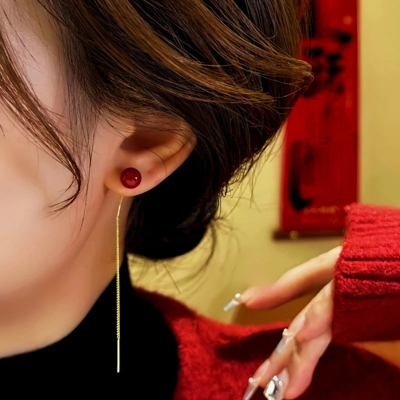 Red Bead Gold Long Tassel Dangle Earring Worn on Ear, Side View