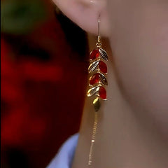 Matching Red Leaf Gold Tassel Drop Earring Worn On Ear Close-up