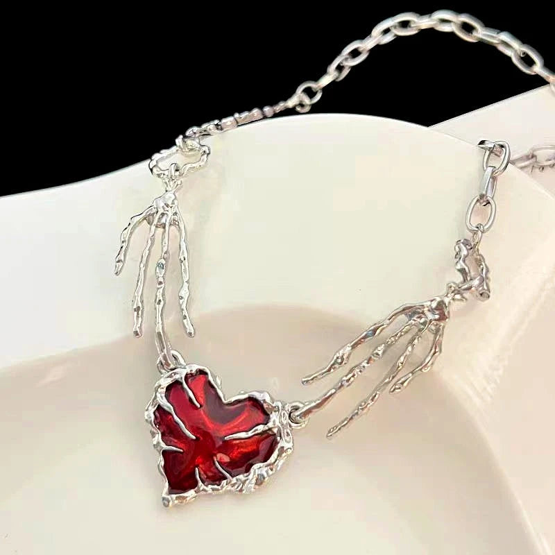 Detailed view of the 14K Gold-Plated Red Diamond Heart Ghost Claw Skeleton Hand Stitching Necklace chain and pendant