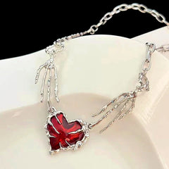 Detailed view of the 14K Gold-Plated Red Diamond Heart Ghost Claw Skeleton Hand Stitching Necklace chain and pendant