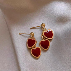 Angled view of the 14K Gold-Plated Red Double Heart Earrings