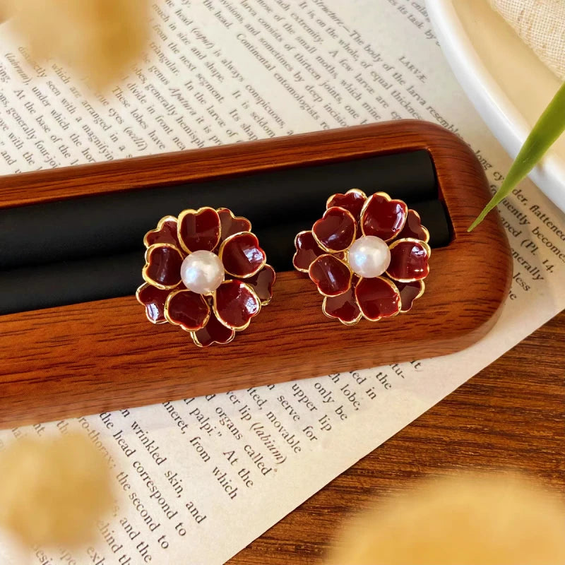 Angled view of the 14K Gold-Plated Red Flower Pearl Stud Earrings