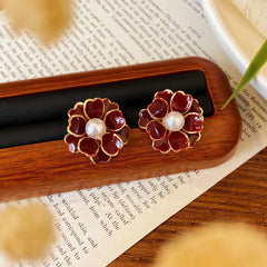 Angled view of the 14K Gold-Plated Red Flower Pearl Stud Earrings