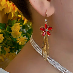 Model showcasing the dangle and style of the 14K Gold-Plated Red Flower Tassel Earrings