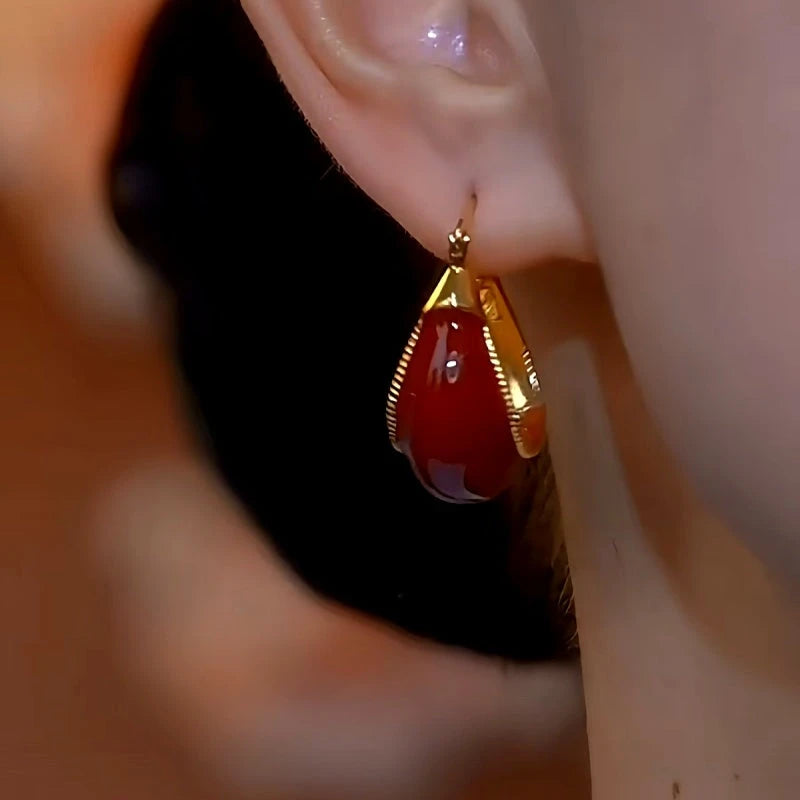 Close-up detail of the sparkling zircons and plating on the Red Gourd Earrings