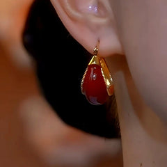 Close-up detail of the sparkling zircons and plating on the Red Gourd Earrings
