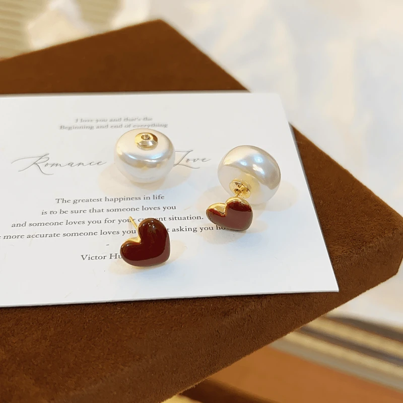 Angled view of the 14K Gold-Plated Red Heart Bead Earrings