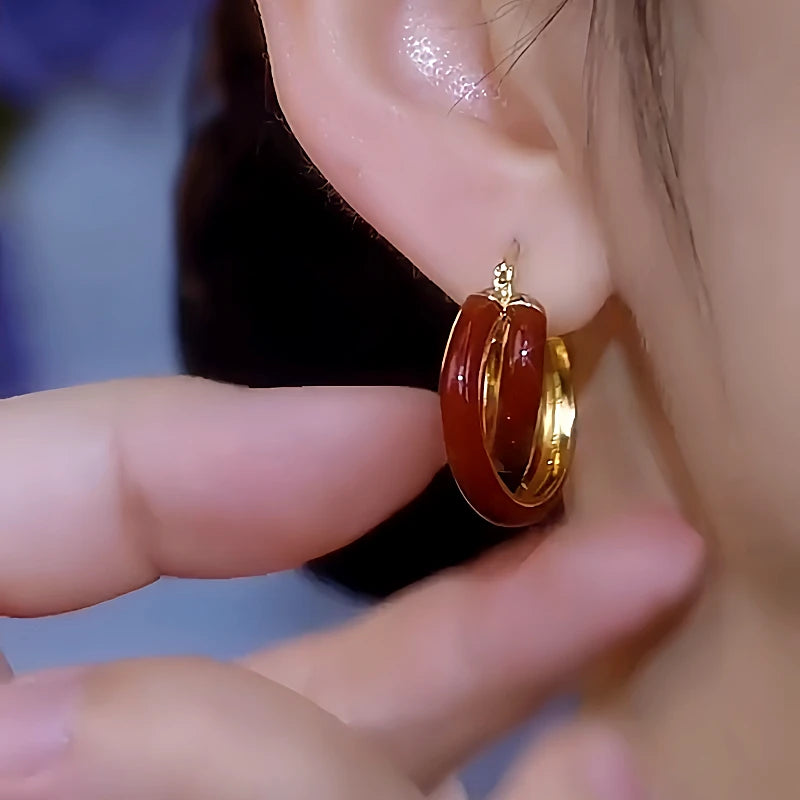 Model showcasing the dangle and style of the 14K Gold-Plated Red Oil-Drop Earrings