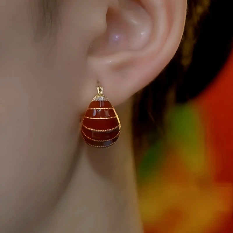 Close-up detail of the sparkling zircons and plating on the Red Bag Earrings