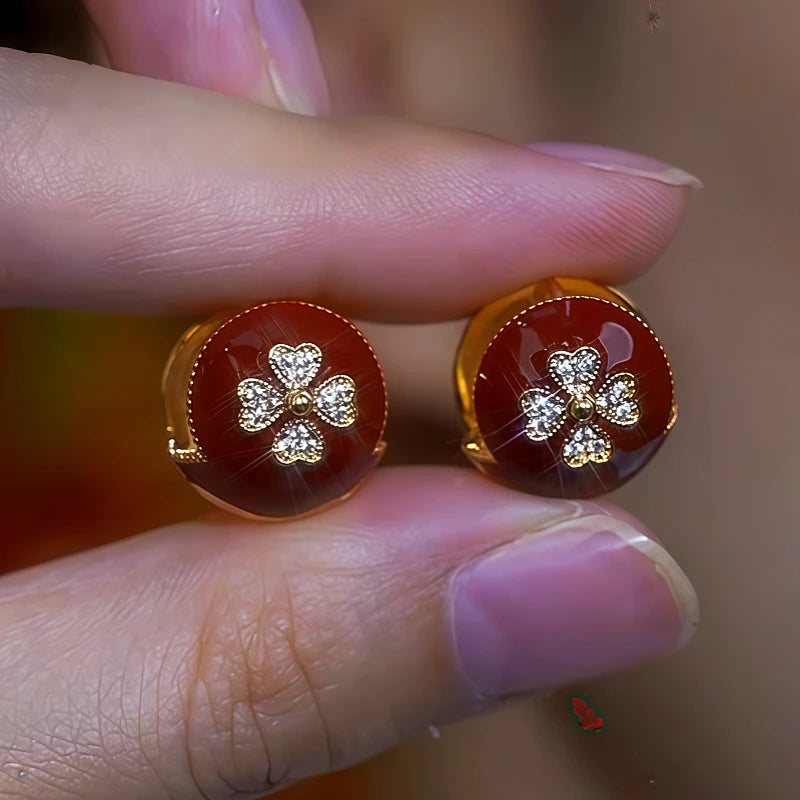 Model showcasing the dangle and style of the 14K Gold-Plated Red Oil Drop Diamond Flower Stud Earrings