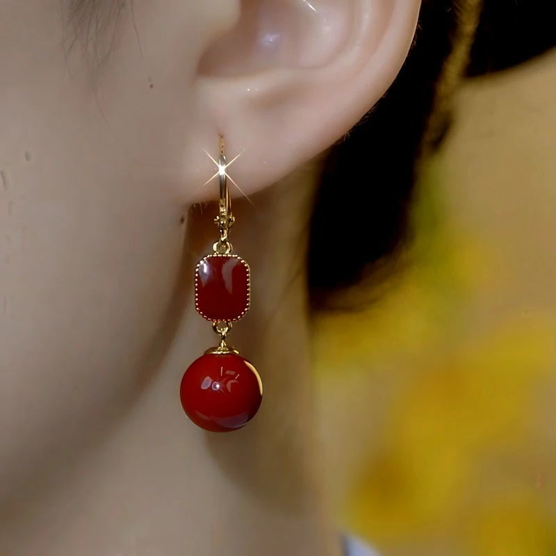 Close-up detail of the sparkling zircons and plating on the Red Pearl Earrings