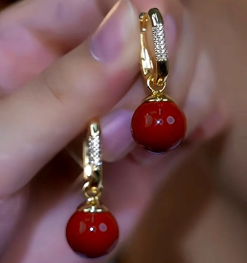 Close-up detail of the sparkling zircons and plating on the Red Pearl Earrings