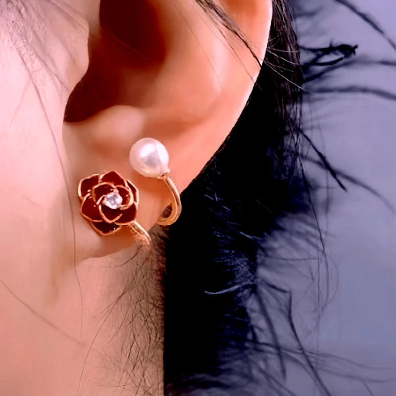 Model showcasing the dangle and style of the 14K Gold-Plated Red Rose Pearl Stud Earrings
