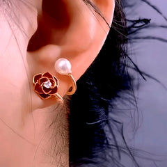 Model showcasing the dangle and style of the 14K Gold-Plated Red Rose Pearl Stud Earrings