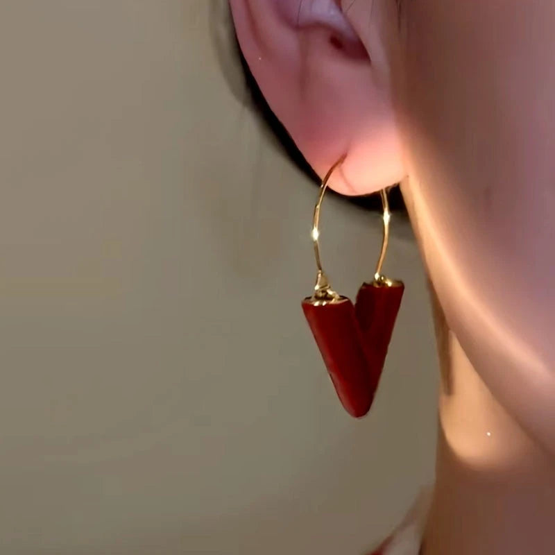 Close-up detail of the sparkling zircons and plating on the V Letter Earrings