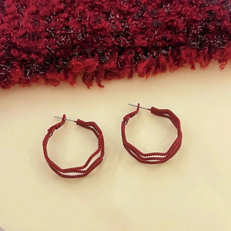 Angled view of the 14K Gold-Plated Red Wavy Three-Layer Hoop Earrings