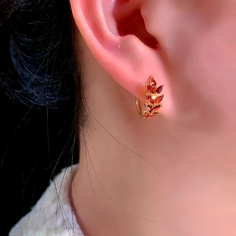 Model showcasing the dangle and style of the 14K Gold-Plated Red Wheat Hoop Earrings