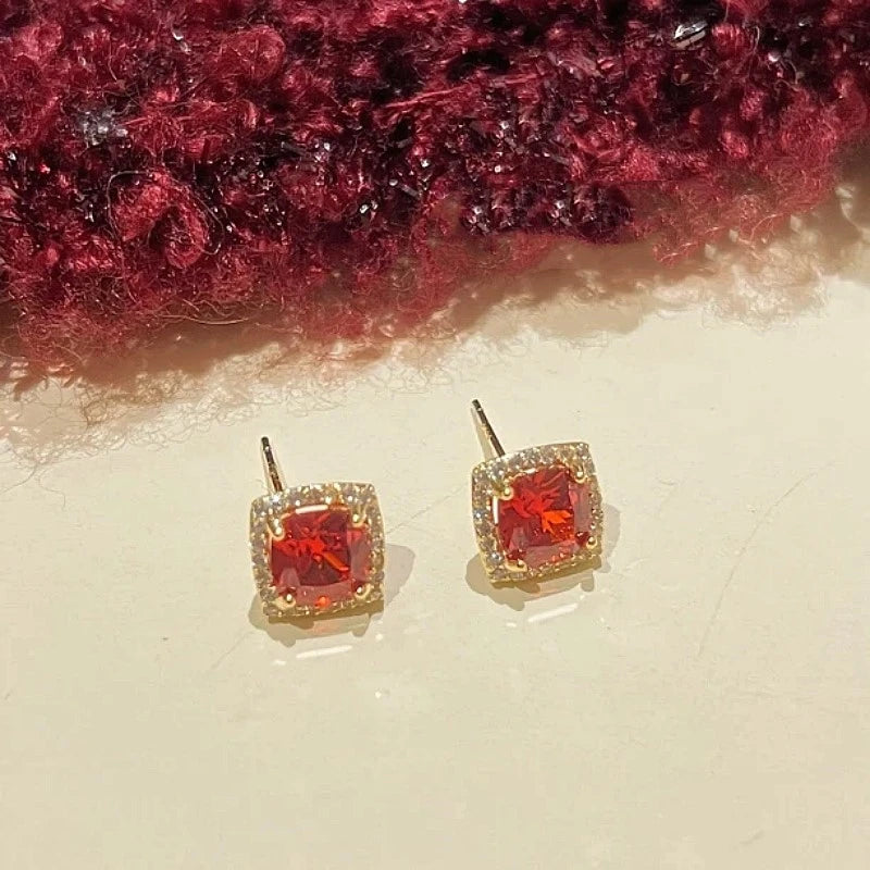 Angled view of the 14K Gold-Plated Red Zircon Stud Earrings