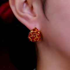 Model showcasing the dangle and style of the 14K Gold-Plated Red Zircon Teardrop Earrings