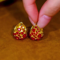 Angled view of the 14K Gold-Plated Red Zircon Teardrop Earrings