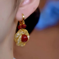 Close-up detail of the sparkling zircons and plating on the Red Pearl Earrings