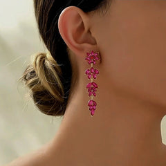 Model showcasing the dangle and style of the 14K Gold-Plated Rhinestone Flower Leaf Tassel Earrings