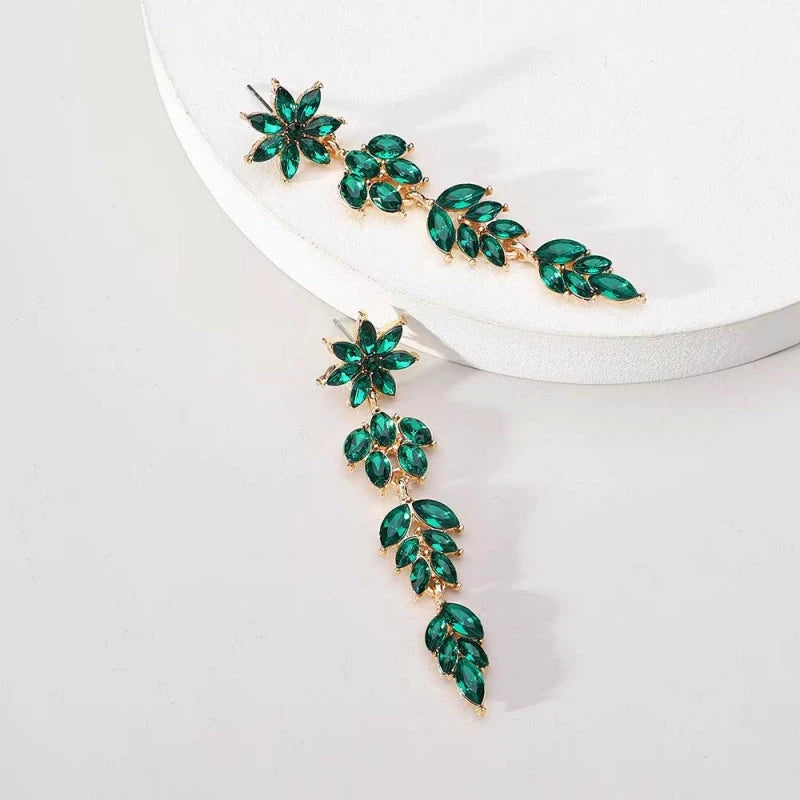 Angled view of the 14K Gold-Plated Rhinestone Flower Leaf Tassel Earrings