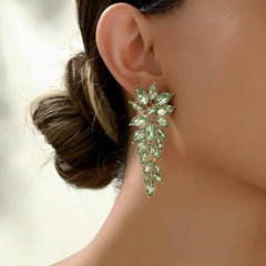 Model showcasing the dangle and style of the 14K Gold-Plated Rhinestonen Wheat Tassel Earrings