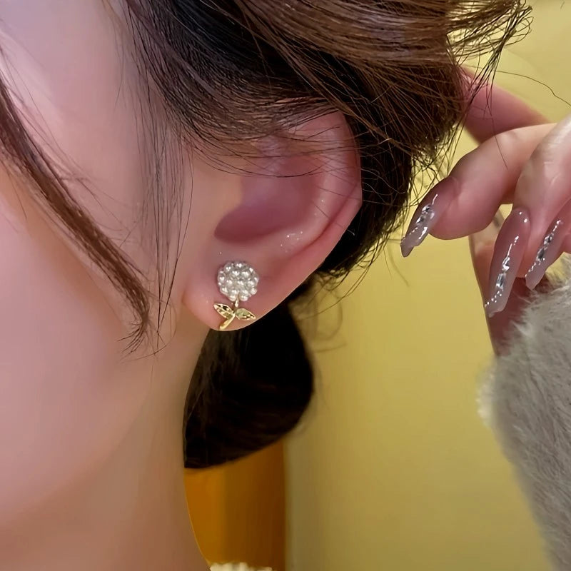 Model showcasing the dangle and style of the 14K Gold-Plated Rice Bead Flower Earrings