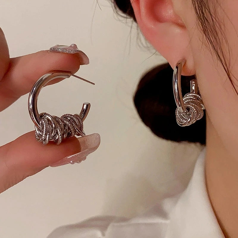 Model showcasing the dangle and style of the 14K Gold-Plated Ring Hoop Earrings