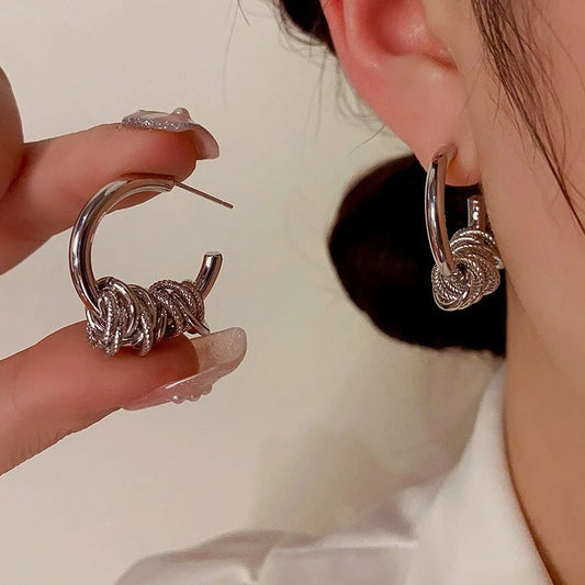 Model showcasing the dangle and style of the 14K Gold-Plated Ring Hoop Earrings