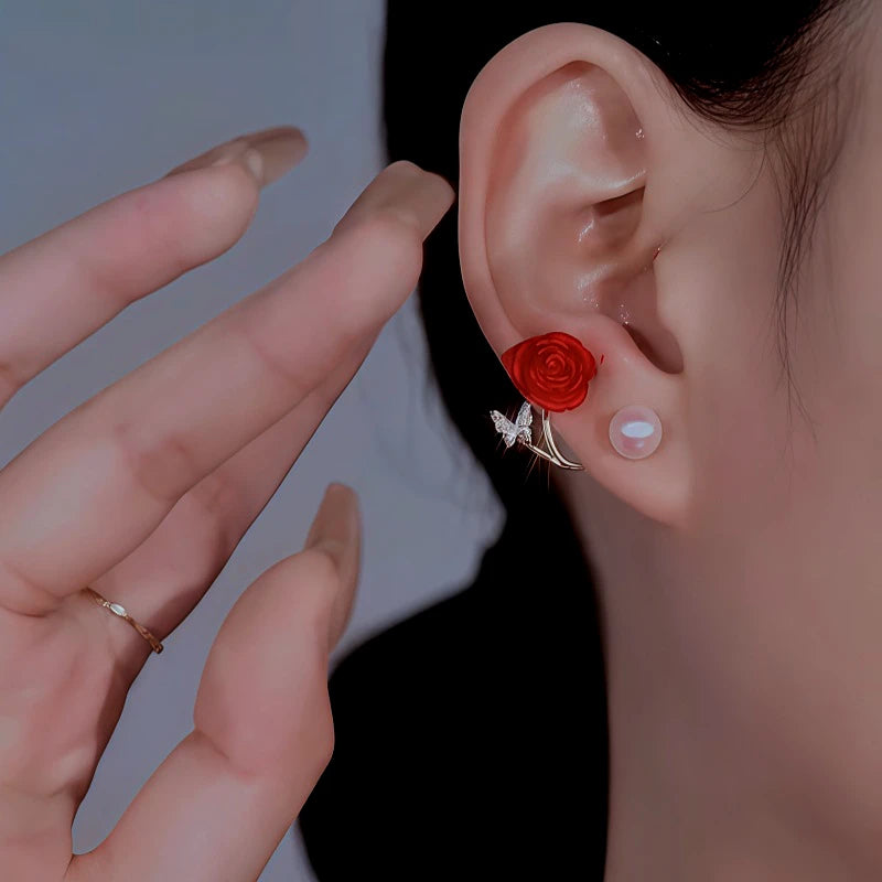Model showcasing the dangle and style of the 14K Gold-Plated Rose Butterfly Pearl Earrings